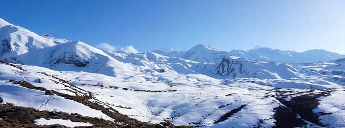 Scenic view of snow covered mountains against sky