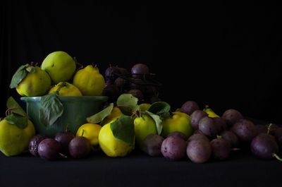Close-up of grapes in container against black background
