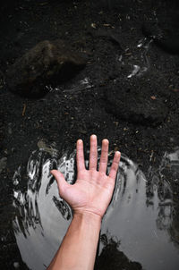 Cropped image of person standing in puddle