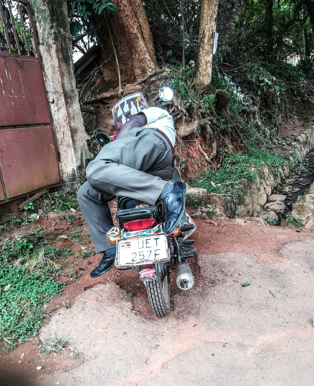 REAR VIEW OF MAN RIDING MOTORCYCLE