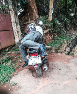 Man riding motorcycle on road