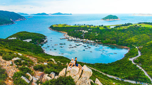 High angle view of sea and mountains against sky