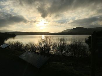 Scenic view of lake at sunset