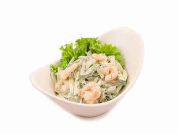 Close-up of food served in bowl against white background