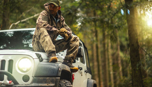 Rear view of man standing in forest