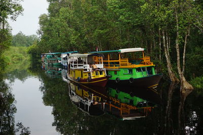 View of boat in river against trees