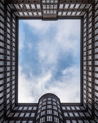 Low angle view of office building against sky