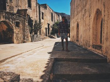 People walking on cobblestone street amidst buildings