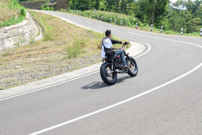 Man riding motorcycle on road