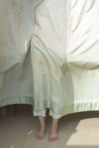 Low section of woman standing on tiled floor