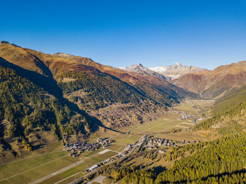 Scenic view of mountains against clear blue sky