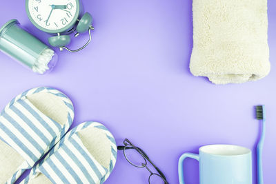 High angle view of personal accessories on purple background