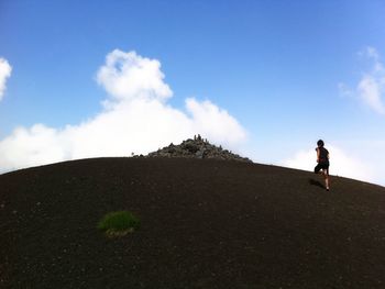 Full length of man standing on land against sky