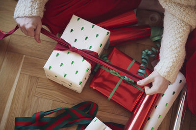 Woman's hands packing christmas presents