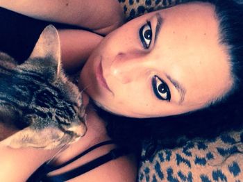 Portrait of young woman lying on bed