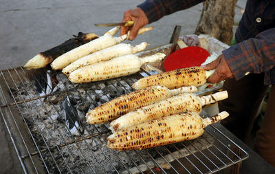Midsection of man preparing food