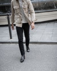 Low section of man standing on footpath