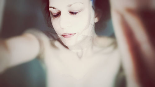 Close-up portrait of young woman at home