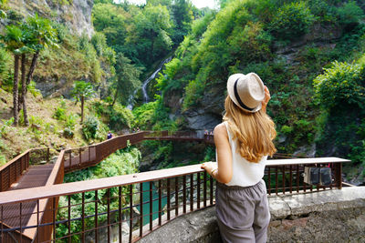 Girl walking in the path enjoying landscape with waterfalls and the gorges of a natural canyon