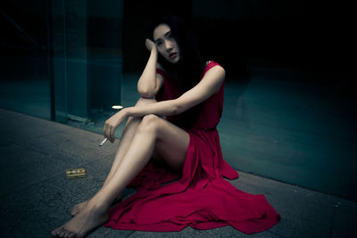 Portrait of a young woman sitting outdoors