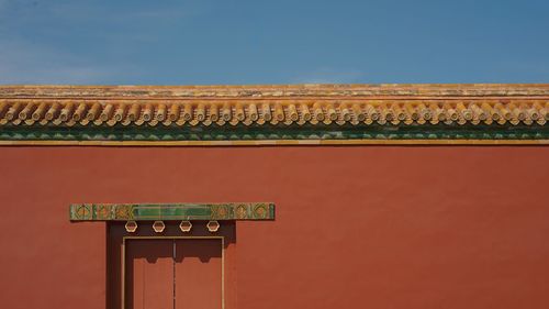 Low angle view of text on building against sky