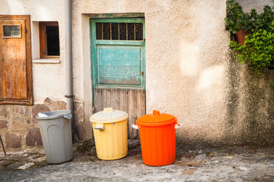 Garbage bins on street against building