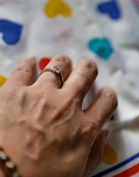 Close-up of hand holding ring