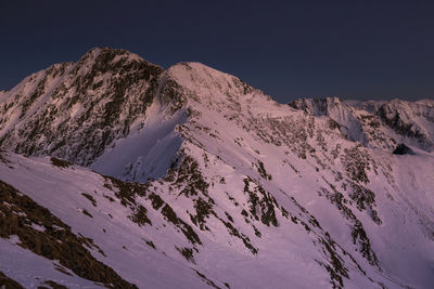 Scenic view of snowcapped mountains against clear sky