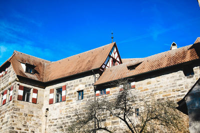 Low angle view of historic building against blue sky