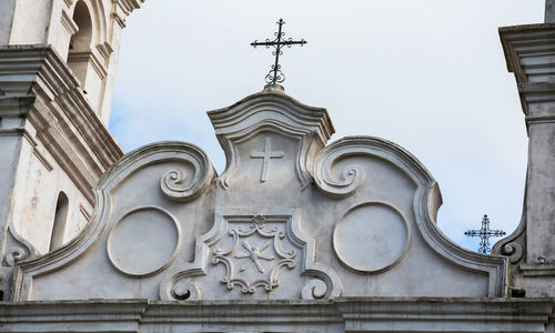 Low angle view of sculptures on building against sky