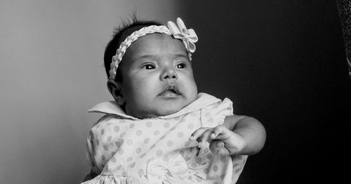 Close-up of cute baby boy against white background