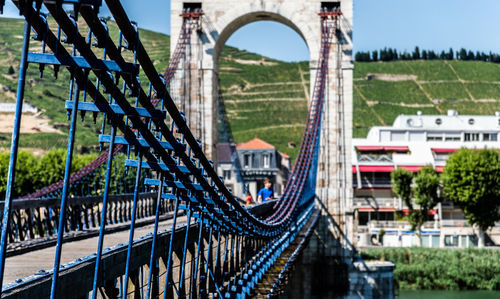 Bridge over city against sky