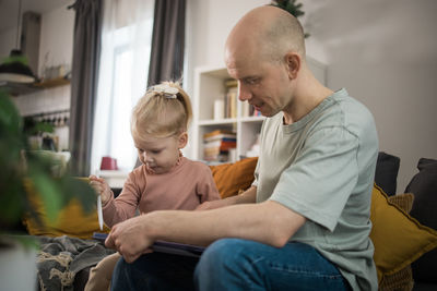 Side view of boy using digital tablet at home