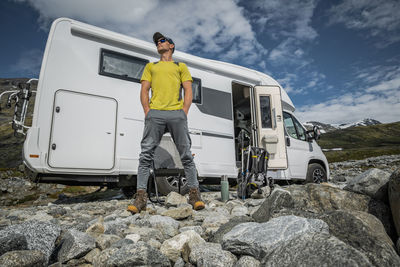 Rear view of man standing on rock