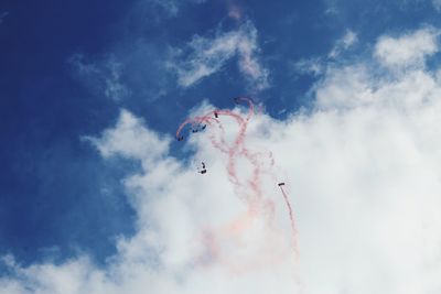 Low angle view of airshow against sky