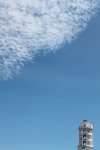 Cloudy blue sky and manado city lighthouse on right corner. diagonal composition