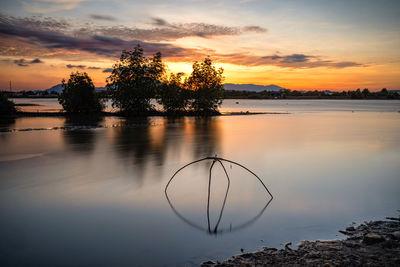 Scenic view of lake against sky during sunset