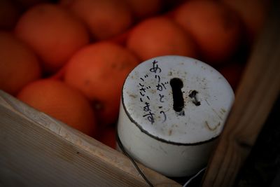 Close-up of container and oranges in crate