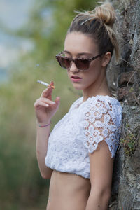 Side view of woman smoking outdoors