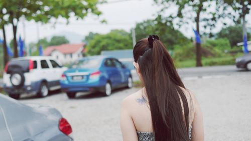 Rear view of woman in parking lot