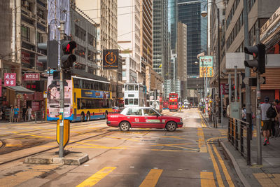 Cars on street against buildings in city