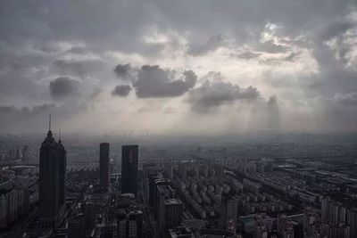 Cityscape against cloudy sky