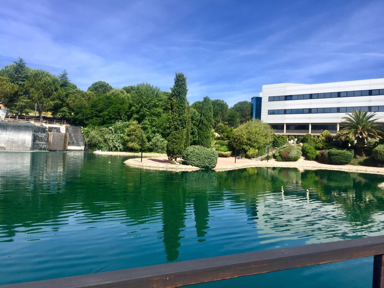 SWIMMING POOL BY LAKE AGAINST BUILDINGS