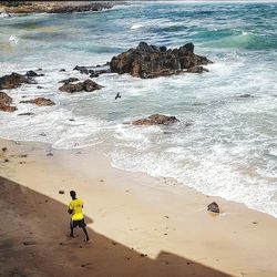 High angle view of man surfing on beach