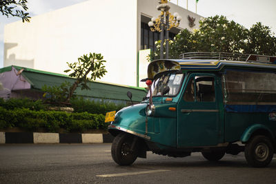 Car on street against buildings