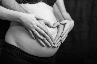 Midsection of woman touching hair