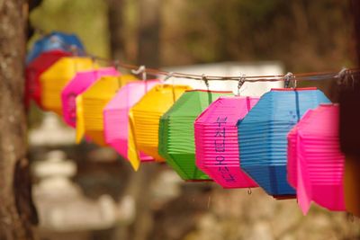 Close-up of multi colored lanterns hanging from cable