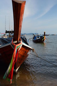 Boats moored on sea against clear sky