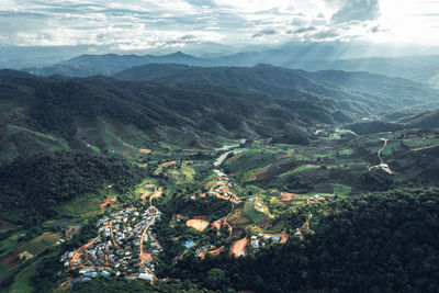 High angle view of land and mountains against sky