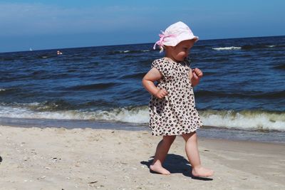 Full length of girl standing on beach